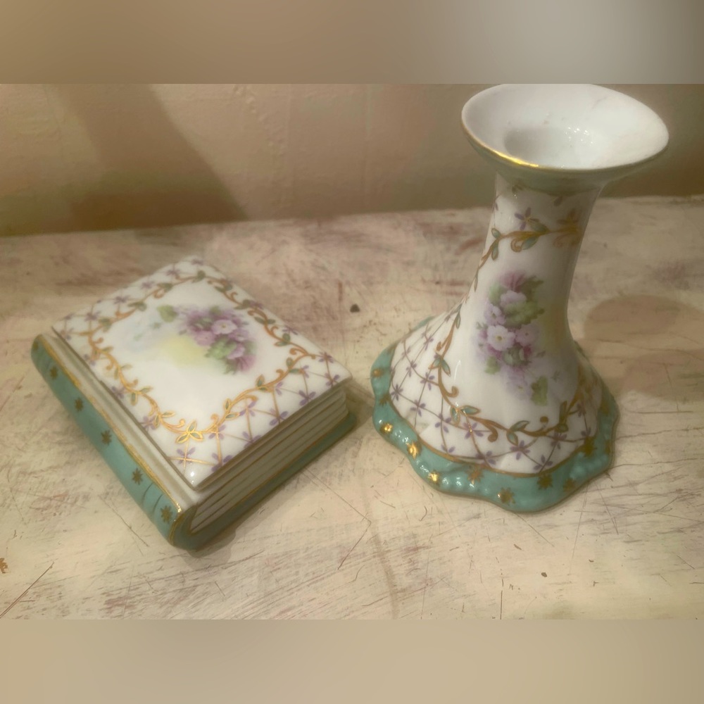 French trinket box that looks like a little book and candlestick.
